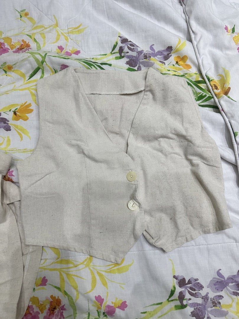 Beige linen blend vest coordinates (Category: Sets or Coordinates) located in Quezon City. Submitted by shop.marga (Listing ID 1446921292, Image 2). Description: - Cute beige linen vest and shorts set - Vest features two buttons, cropped - Shorts have an elastic waistband and pockets - Ideal for a casual, comfortable look - Perfect for warmer weather - For S-M.