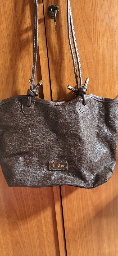 Brown Leather Tote Bag by Lim&Co (Category: Tote Bags) located in Malabon City. Submitted by ph_ohkaye (Listing ID 1446964185, Image 1). Description: - Brand: Lim&Co. - Color: Brown - Material: Textured faux leather - Features: Cute flower charm, spacious black interior - Style: Simple, classic, great for everyday use.