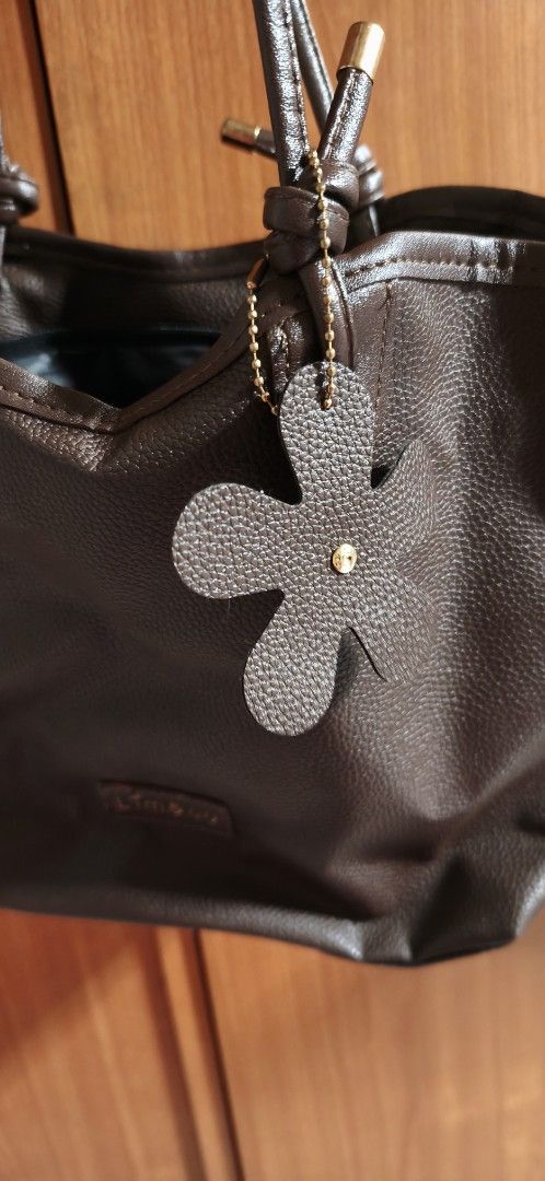 Brown Leather Tote Bag by Lim&Co (Category: Tote Bags) located in Malabon City. Submitted by ph_ohkaye (Listing ID 1446964185, Image 3). Description: - Brand: Lim&Co. - Color: Brown - Material: Textured faux leather - Features: Cute flower charm, spacious black interior - Style: Simple, classic, great for everyday use.