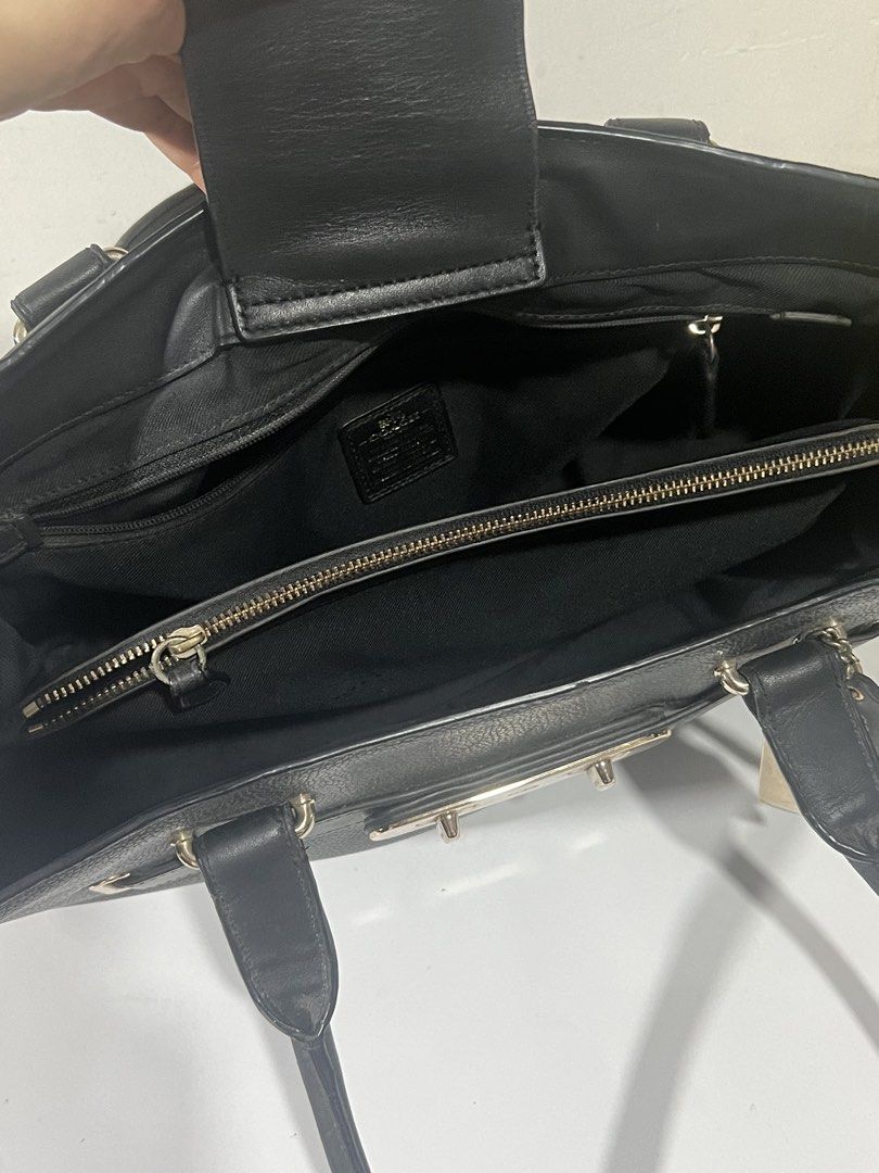 Coach Black Leather Tote Bag with Turnlock Closure (Category: Luxury Bags & Wallets) located in Santa Rosa. Submitted by rubywednesdays (Listing ID 1447019439, Image 3). Description: - Authentic Coach black leather tote bag - Features a stylish front turnlock closure - Comfortable double top handles for easy carrying - Includes original Coach hangtag - Spacious interior, ideal for everyday essentials - Timeless and clean design.