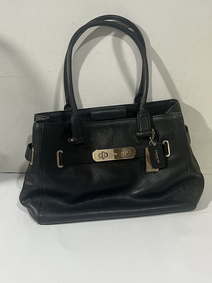 Coach Black Leather Tote Bag with Turnlock Closure (Category: Luxury Bags & Wallets) located in Santa Rosa. Submitted by rubywednesdays (Listing ID 1447019439, Image 1). Description: - Authentic Coach black leather tote bag - Features a stylish front turnlock closure - Comfortable double top handles for easy carrying - Includes original Coach hangtag - Spacious interior, ideal for everyday essentials - Timeless and clean design.