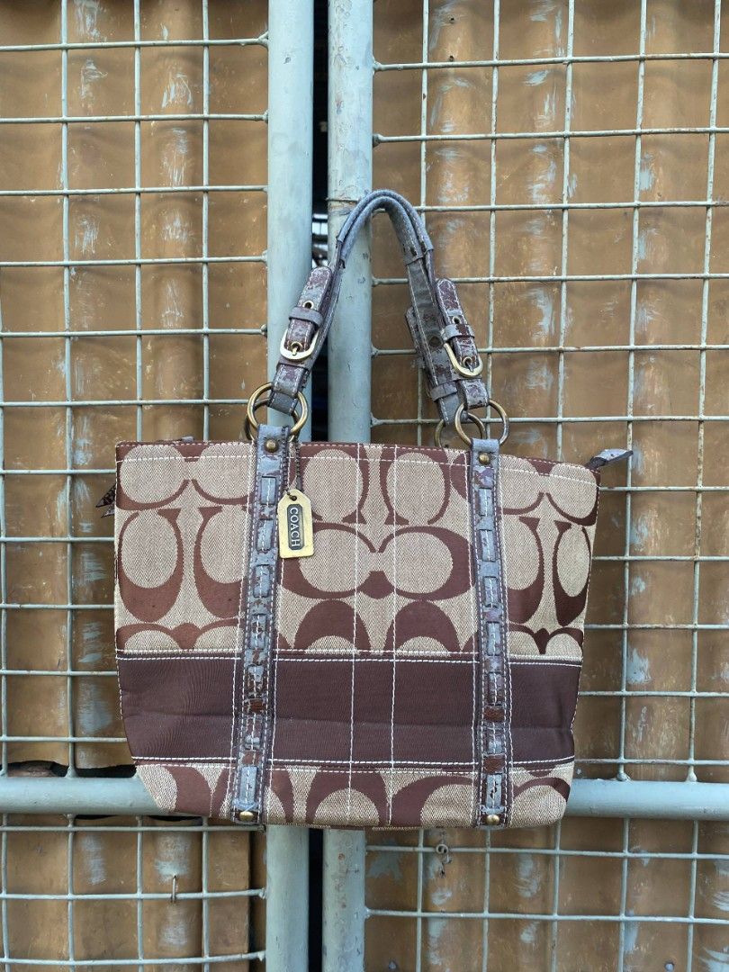 Coach Monogram Canvas & Leather Trim Tote Bag (Category: Luxury Bags & Wallets) located in Manila. Submitted by mordaxfinds (Listing ID 1447023271, Image 1). Description: - Authentic Coach monogram canvas tote - Classic brown leather trim and handles - Interior features multiple pockets for organization - Secure zip closure - Overall good pre-loved condition - Minor wear on interior leather tag - Very spacious, perfect for daily essentials.