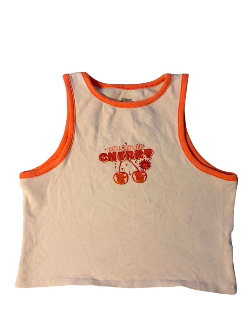 Cotton On Graphic Tank Top - Original Cherry (Category: Sleeveless) located in Baguio. Submitted by gabriyelo (Listing ID 1447053500, Image 1). Description: - Cream colored tank top - Orange trim detail - Features 'Original Cherry' graphic on front - Sleeveless design - Ideal for casual wear - Made in Bangladesh - Size: Medium (M/M).