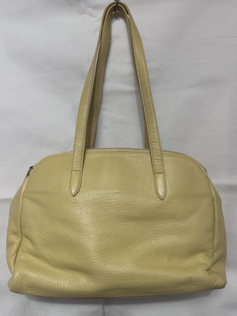 Courreges Paris Leather Shoulder Bag (Category: Luxury Bags & Wallets) located in San Juan City. Submitted by vrgyl (Listing ID 1447020474, Image 3). Description: pls. manage expectations, preloved item with signs of discoloration and rubs on corners of bag - Light yellow leather shoulder bag from Courreges Paris - Features a secure zip closure and a stylish front clasp detail - Interior zip pocket with a small, unnoticeable stain - Some signs of