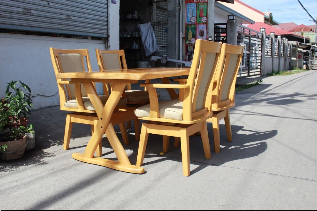 Dining Set (Category: Tables & Sets) located in Meycauayan. Submitted by marygracecasimiro (Listing ID 1447005463, Image 3). Description: Solid Wood Modern 4-Seater Dining Set Sturdy 4-seater solid wood dining set with a rectangular table supported by a heavy-duty X-shaped trestle base. 4 matching Captain's swivel armchairs with padded leather seats and backrests, wooden armrests and smooth 360° swivel function. A durable and comfortable dining s
