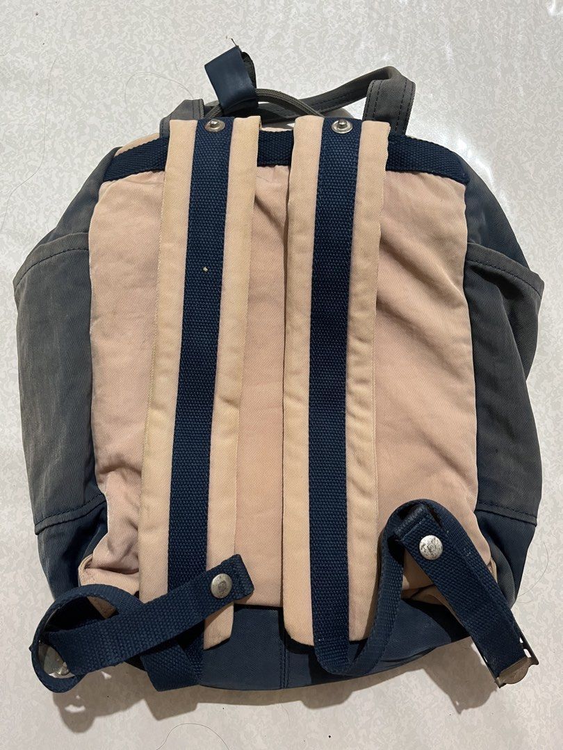 Doughnut Backpack (Category: Backpacks) located in Caloocan City. Submitted by ryspace (Listing ID 1447078659, Image 2). Description: - Brand: Doughnut - Colorway: Navy blue and pink - Features: Multiple pockets, buckle closures on front, adjustable straps - Condition: Some signs of wear, but still functional - Ideal for: Everyday use or travel - Capacity: 18L.