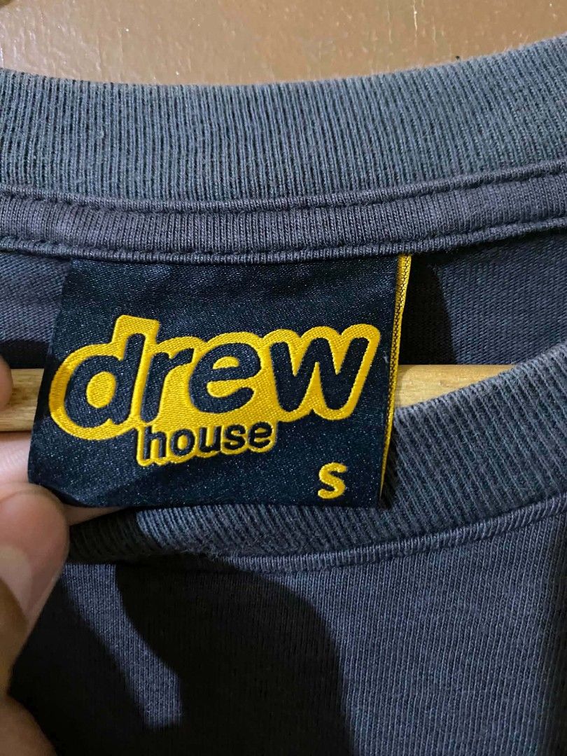 Drew House T-Shirt Size S (Category: Tshirts & Polo Shirts ) located in Taguig. Submitted by cabugchear34421 (Listing ID 1447053983, Image 3). Description: - Drew House graphic tee - Yellow 'drew house' text on front - Size: S - Condition: Good, with some minor stain on the front - 8/10 color rate - Dm.