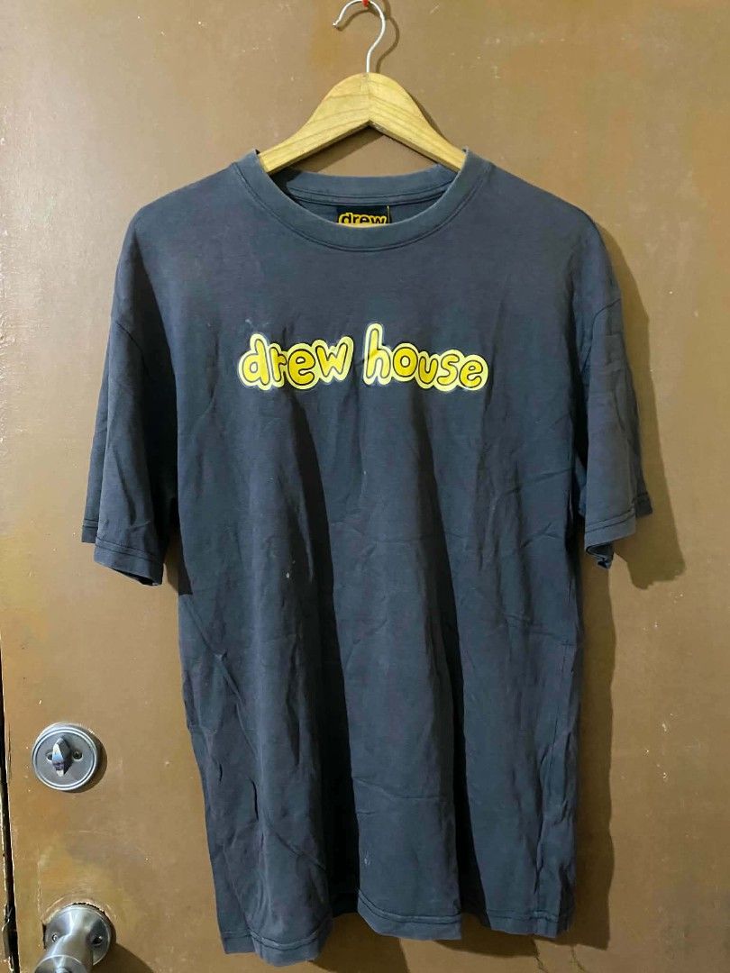 Drew House T-Shirt Size S (Category: Tshirts & Polo Shirts ) located in Taguig. Submitted by cabugchear34421 (Listing ID 1447053983, Image 2). Description: - Drew House graphic tee - Yellow 'drew house' text on front - Size: S - Condition: Good, with some minor stain on the front - 8/10 color rate - Dm.