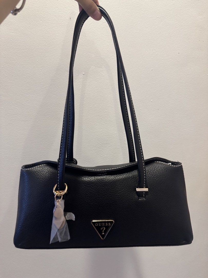 Guess Black Pebble Leather Shoulder Bag with Tag (Category: Shoulder Bags) located in San Pablo. Submitted by simplicitybeaute (Listing ID 1447055751, Image 1). Description: - Black Guess shoulder bag - Pebble leather texture - White contrast stitching - Gold hardware details - Comes with original tag and charm - Clean interior - Ideal for everyday use.
