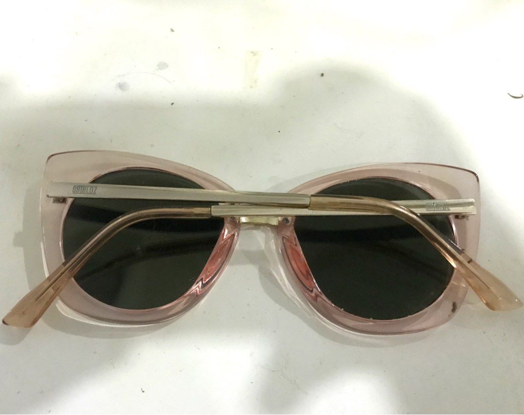 H&M Sunglasses - Pink Cat Eye (Category: Sunglasses & Eyewear) located in Manila. Submitted by sparkfinds (Listing ID 1447020584, Image 2). Description: - Unique pink cat-eye sunglasses - Mirrored lenses with a subtle green tint - Gold metal accents on the arms - Adds flair to any outfit.