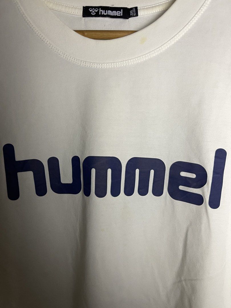 Hummel White T-Shirt with Blue Logo (Category: Tshirts & Polo Shirts ) located in Manila. Submitted by andrada_jamie (Listing ID 1446994903, Image 2). Description: 28.5x23.5 - White Hummel t-shirt - Blue Hummel logo across the chest - Minor marks present (please check photos) - Perfect for casual everyday wear.