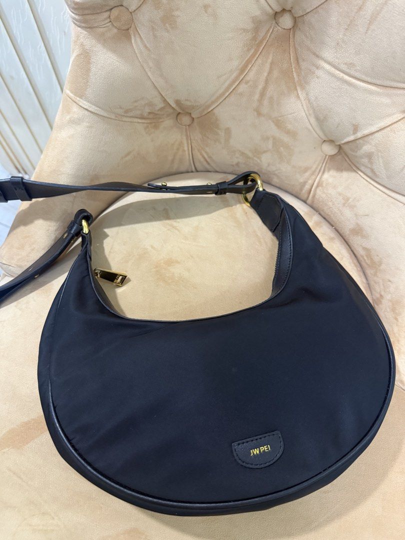 JW PEI CARLY SHOULDER BAG (Category: Luxury Bags & Wallets) located in Angeles City. Submitted by bagpriceinfiniteluck (Listing ID 1447015161, Image 3). Description: Jw pei CARLY SHOULDER BAG crafted from durable Nylon and features gold toned hardware This model is designed as a crescent or saddle shaped bag Includes an adjustsble shoulder strap for versatile carrying options This bag is made from sustainable materials using recycled plastic from