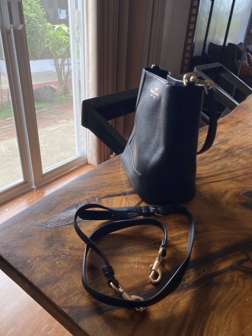 Kate Spade Black Leather Bucket Bag with Strap (Category: Shoulder Bags) located in Quezon City. Submitted by greshanicoche (Listing ID 1446914645, Image 2). Description: - Authentic Kate Spade black leather bucket bag - Textured leather finish for a sophisticated look - Includes a detachable crossbody strap for versatile carrying options - Elegant gold hardware details - Spacious interior, ideal for carrying your essentials - Perfect for everyda