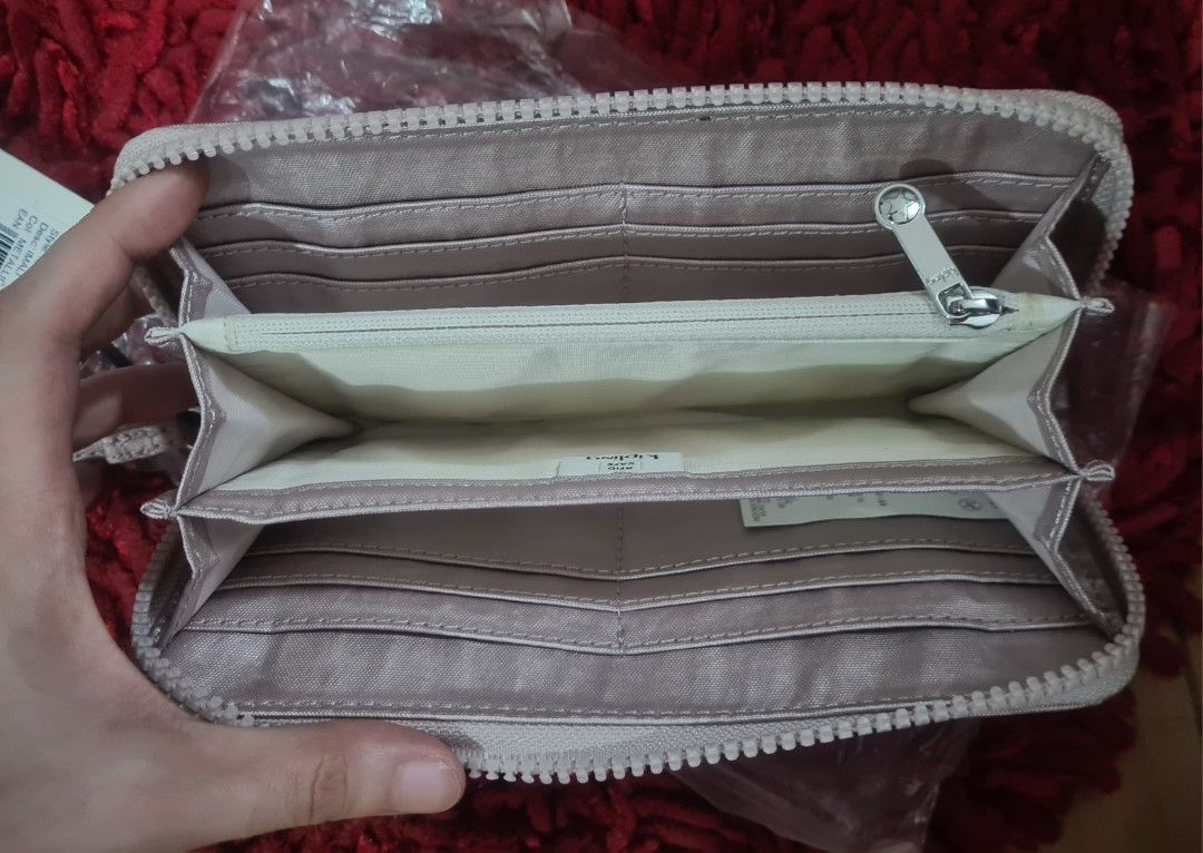 Kipling Basic Wallet Rose Gold (Category: Wallets & Card holders) located in Paranaque City. Submitted by lorem45 (Listing ID 1447020608, Image 3). Description: - Brand new Kipling wallet - Elegant rose gold color - Secure zip-around closure - Ample card slots and compartments for organization - Convenient wrist strap included - Still in original packaging - Ideal for keeping your essentials tidy and accessible.