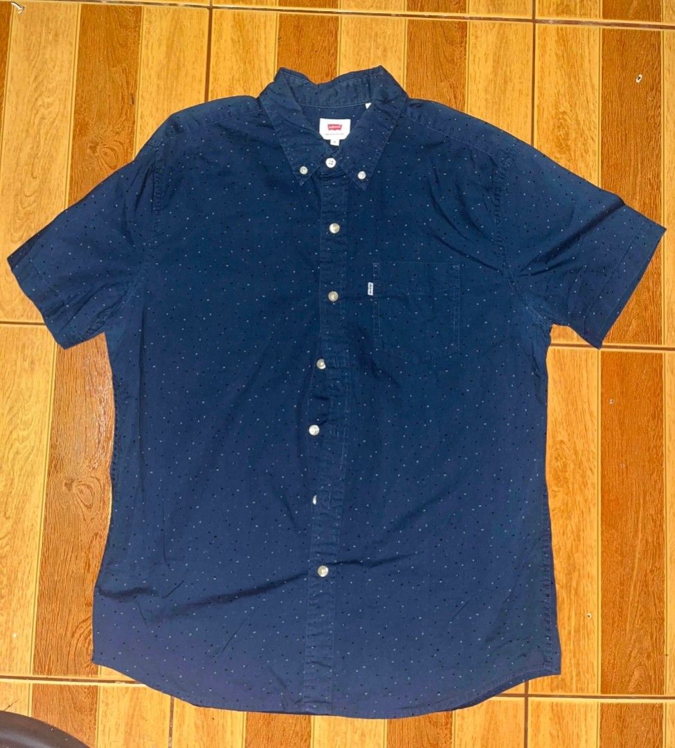 Levi's Blue Short Sleeve Button Up Shirt (Category: Tshirts & Polo Shirts ) located in Quezon City. Submitted by sheyn.anya (Listing ID 1446923059, Image 1). Description: - Classic Levi's short sleeve shirt - Dark blue with subtle all-over dot pattern - Button-up front - Chest pocket - Size: Large - Ideal for casual wear.