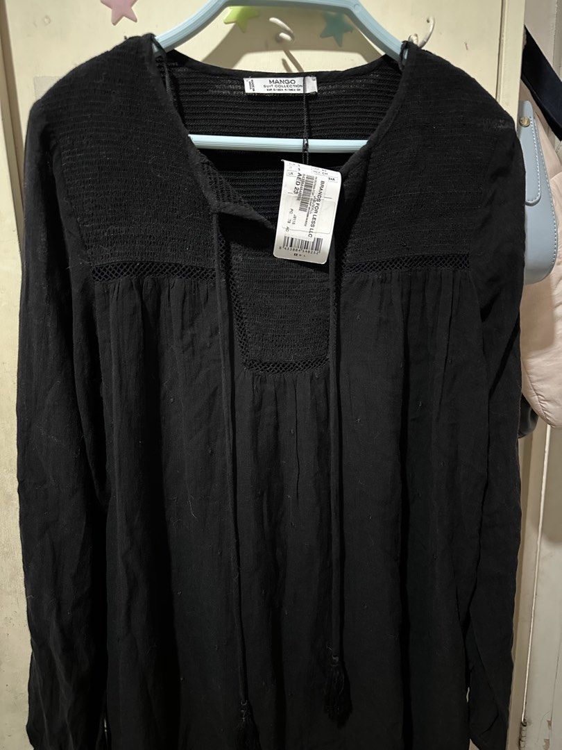 Mango Black Long Sleeve Tunic Top with Tassels (Category: Blouses) located in Davao. Submitted by gentledeer_36a645 (Listing ID 1446990635, Image 1). Description: - Brand: Mango - Color: Black - Style: Long sleeve top - Features: Smocked bodice, neckline tie with tassels - Fabric: Lightweight and flowy - Occasion: Casual wear - Size: S - Condition: Brand new with tags attached.