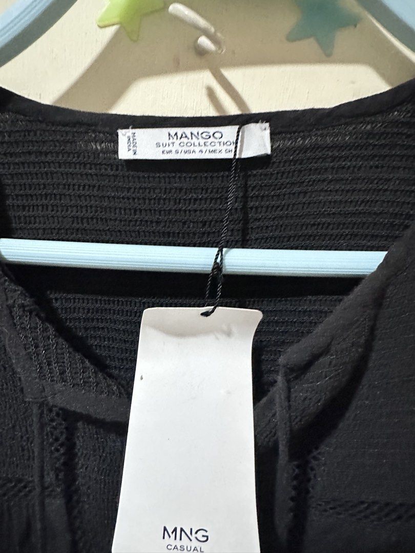 Mango Black Long Sleeve Tunic Top with Tassels (Category: Blouses) located in Davao. Submitted by gentledeer_36a645 (Listing ID 1446990635, Image 3). Description: - Brand: Mango - Color: Black - Style: Long sleeve top - Features: Smocked bodice, neckline tie with tassels - Fabric: Lightweight and flowy - Occasion: Casual wear - Size: S - Condition: Brand new with tags attached.