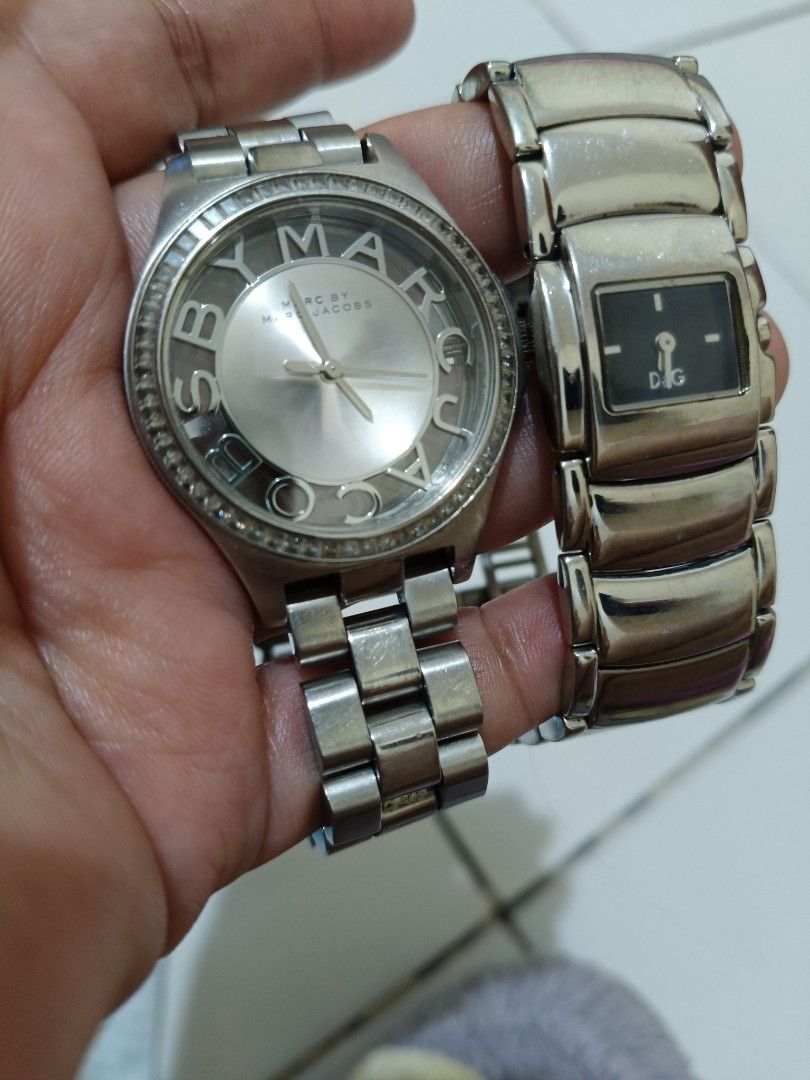 Marc by Marc Jacobs and D&G Watches Bundle (Category: Women's Watches) located in Bocaue. Submitted by ac465881 (Listing ID 1447017270, Image 1). Description: - Two silver-toned metal watches for sale. - Marc by Marc Jacobs watch: Features a silver dial and sparkling m crystal bezel. - D&G watch: Boasts a sleek black rectangular face and a silver band. - Ideal for everyday fashion or adding to your watch collection..
