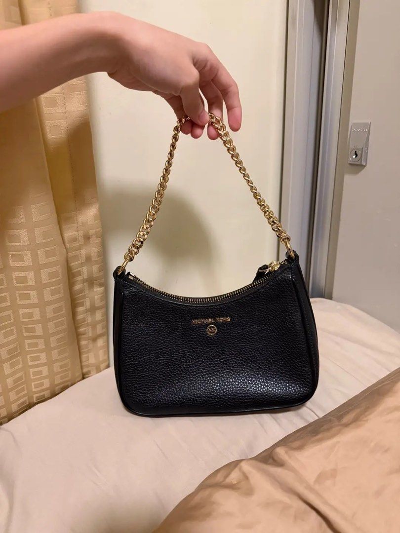 Michael Kors Black Leather Chain Shoulder Bag (Category: Luxury Bags & Wallets) located in Tarlac. Submitted by never.wearing (Listing ID 1447048241, Image 2). Description: - Brand: Michael Kors - Material: Black pebbled leather - Strap: Gold chain - Closure: Zipper - Interior: Card slots - Size: Small and compact, perfect for essentials - Condition: Clean inside and out - Hardware: Shiny gold hardware GENUINE LEATHER PWEDE NATIN PA LEGIT GRAILS 