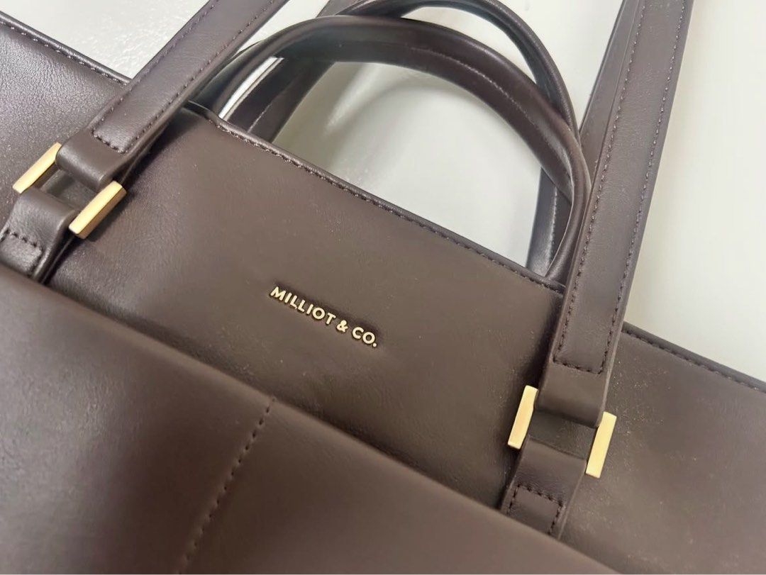 MILLIOT & CO. Dark Brown Leather Tote Bag (Category: Tote Bags) located in Sepang. Submitted by nurulnuru86598 (Listing ID 1446974879, Image 2). Description: - Dark brown tote bag from MILLIOT & CO. - Convenient front pocket. - Comfortable, good-length handles for carrying. - Spacious interior, perfect for work or daily essentials. - Never use and like NEW!!.