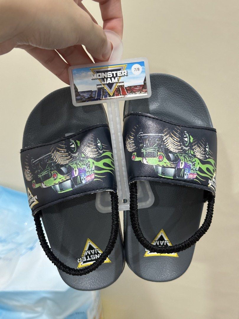 Monster Jam Kids Slides with strap slippers (Category: Babies & Kids Fashion) located in Manila. Submitted by sammiegm (Listing ID 1447032647, Image 1). Description: BOUGHT THIS FROM AMAZON USA BEST FIT for toddlers size 6C RFS: RUNS TOO SMALL (my son is a size 8C) - Cool Monster Jam slides for kids - Features fun monster truck graphic on straps - Easy slip-on style - Back elastic strap for a secure fit - Monster Jam logo on insoles - Perfect for