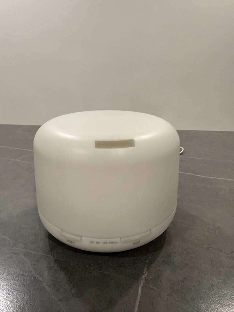 Muji Diffuser (Category: Home Fragrance) located in Singapore. Submitted by friday.13 (Listing ID 1447042449, Image 1). Description: - White essential oil diffuser - 2 warm light settings - Mist Timer settings: 30, 60, 120, 180 minutes - Top lifts off for easy water reservoir access - Power cord included - In good working condition.