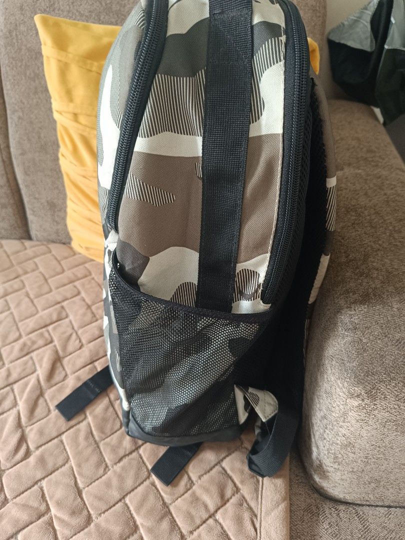 Nike Camo Backpack (Category: Backpacks) located in Marikina City. Submitted by belle0903 (Listing ID 1446958978, Image 3). Description: - Stylish Nike backpack with a cool camouflage design. - Features the iconic Nike swoosh logo. - Includes convenient side mesh pockets for water bottles or essentials. - Padded shoulder straps ensure comfortable carrying. - Ideal for school, gym sessions, or everyday adventures..