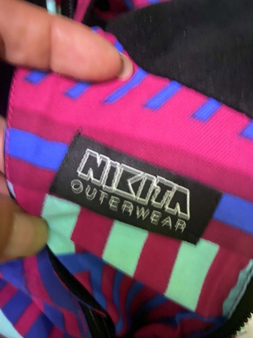 Nikita Outerwear Hoodie Jacket (Category: Coats, Jackets and Outerwear) located in Caloocan City. Submitted by JennMT (Listing ID 1447102308, Image 2). Description: - Cool Nikita hoodie jacket - Unique geometric pattern (purple, blue, mint green) - Features a hood - Button closure at the neck - Size: Large (L) - Ideal for layering or as a statement piece.