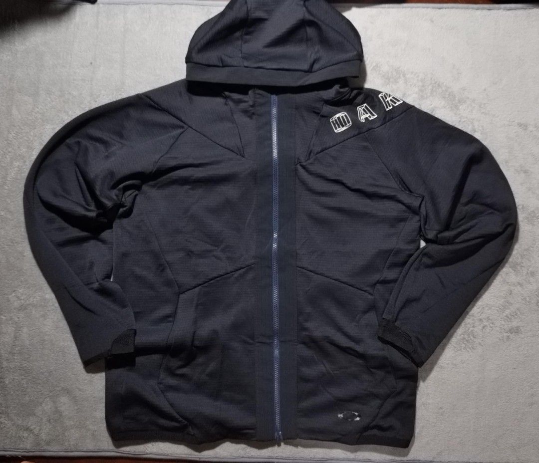 Oakley Black Full Zip Hoodie Jacket (Category: Coats, Jackets and Outerwear) located in Tacloban City. Submitted by elleriaebi57895 (Listing ID 1447072128, Image 1). Description: - Black Oakley hoodie jacket - Full zip front with hood - Oakley logo on chest and sleeve - Two front pockets - Made with performance fabric - Ideal for workouts or casual wear.