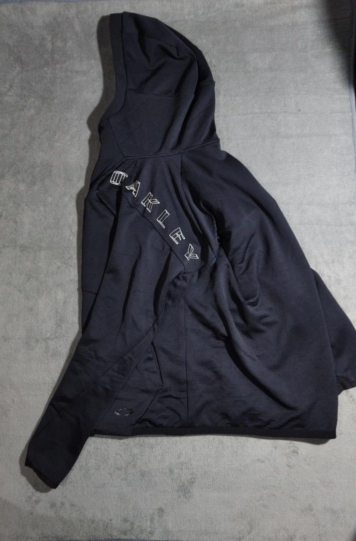 Oakley Black Full Zip Hoodie Jacket (Category: Coats, Jackets and Outerwear) located in Tacloban City. Submitted by elleriaebi57895 (Listing ID 1447072128, Image 2). Description: - Black Oakley hoodie jacket - Full zip front with hood - Oakley logo on chest and sleeve - Two front pockets - Made with performance fabric - Ideal for workouts or casual wear.