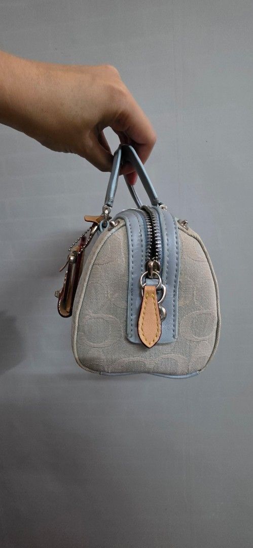 Original Coach ruby Denim Mini Barrel (Category: Luxury Bags & Wallets) located in Pasig City. Submitted by lfboutique (Listing ID 1447038921, Image 3). Description: - original and preloved Coach ruby - Signature light blue denim print - Top handles - Detachable crossbody strap - Includes leather hang tags - Ideal for carrying essentials micro size but fits big phones so cute pasig loc payment first or upon pick up .