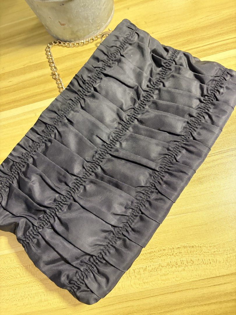 Prada Ruched Clutch Bag with Gold Chain (Category: Luxury Bags & Wallets) located in Manila. Submitted by neri_declutters (Listing ID 1447091466, Image 2). Description: - Authentic Prada clutch in dark grey - Elegant ruched fabric design - Detachable gold chain strap - Ideal for evening wear and special occasions - issue: missing R.