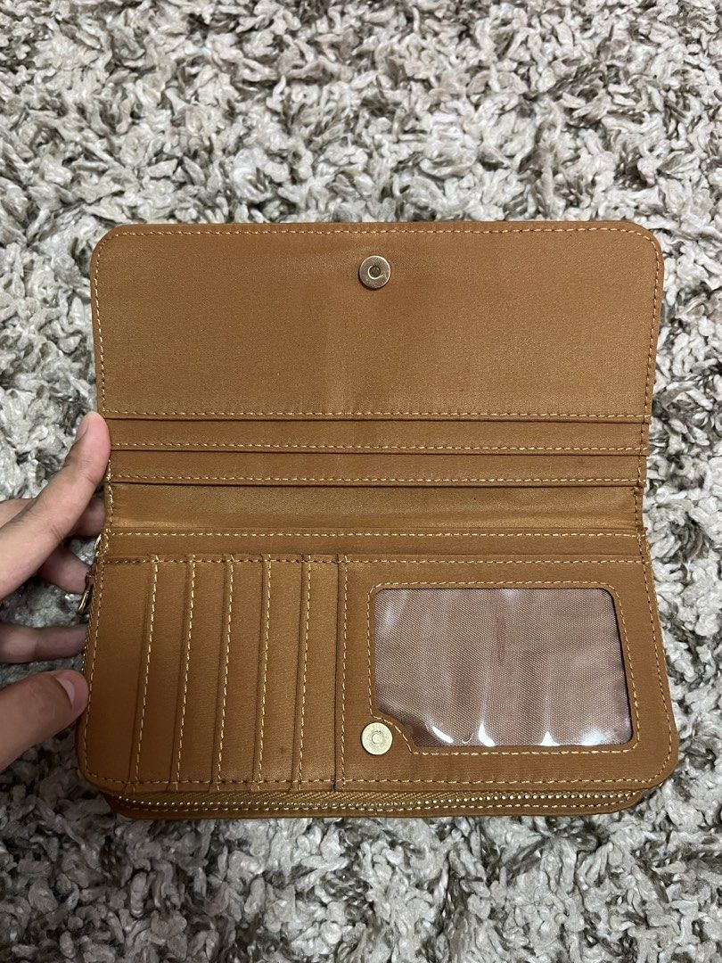 Riviera Brown Zip Around Wallet (Category: Wallets & Card holders) located in Pasay City. Submitted by losient (Listing ID 1447012302, Image 3). Description: - Brown Riviera wallet - Zip-around closure for security - Ample card slots for all your cards - Clear ID window for easy access - Dedicated coin compartment - Embossed Riviera brand inside - Ideal for keeping your essentials organized.
