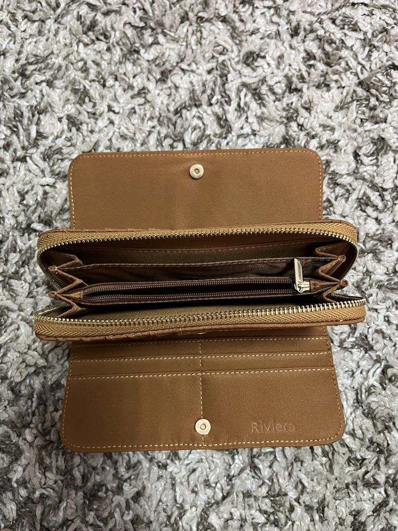 Riviera Brown Zip Around Wallet (Category: Wallets & Card holders) located in Pasay City. Submitted by losient (Listing ID 1447012302, Image 2). Description: - Brown Riviera wallet - Zip-around closure for security - Ample card slots for all your cards - Clear ID window for easy access - Dedicated coin compartment - Embossed Riviera brand inside - Ideal for keeping your essentials organized.