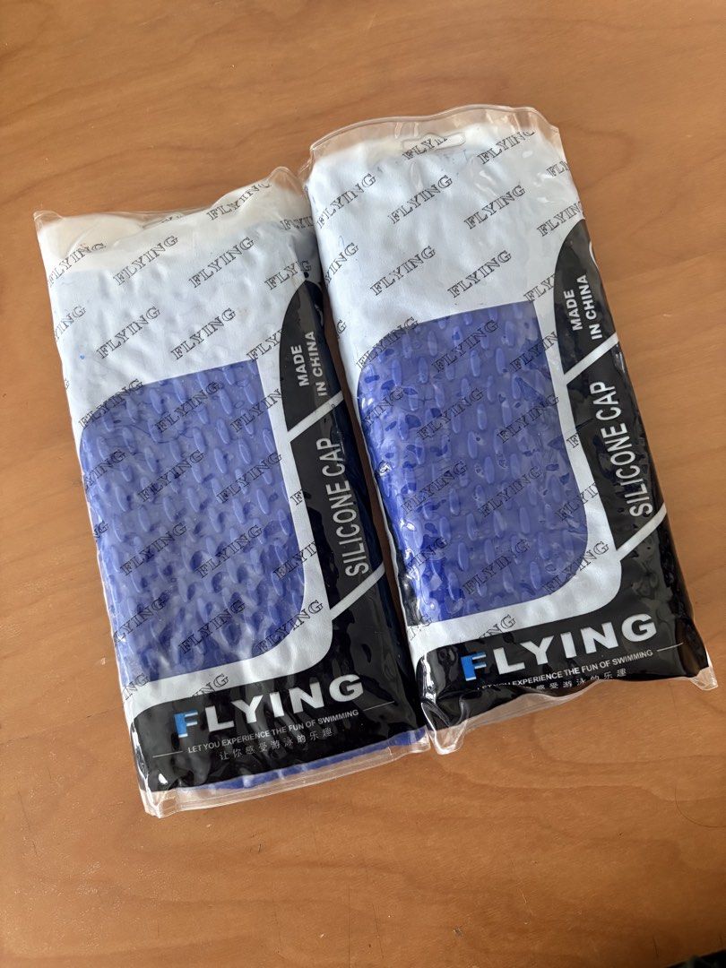 Swimming cap (Category: Water Sports) located in Singapore. Submitted by navybluedenimjeans (Listing ID 1447077458, Image 1). Description: - Set of 2 Flying silicone swimming caps - Color: Blue - Material: Silicone - Origin: Made in China.