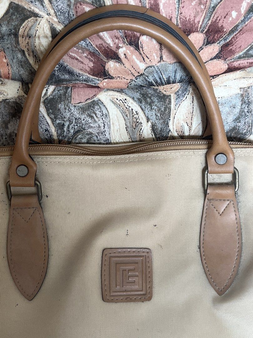 Tan Canvas Duffel Bag with Leather Accents (Category: Sling Bags) located in Los Banos. Submitted by profemy (Listing ID 1446973087, Image 2). Description: Vintage Pierre Balmain nylon Boston bag - Spacious interior, ideal for travel or gym, or for ocernight/weekend local travel. no tears, but with some fading/discoloration. width -55 cm at tge widest point; Height - 36 cm at the center. depth (bottom), about 15 cm) Will ship by J&T , buyer shoul