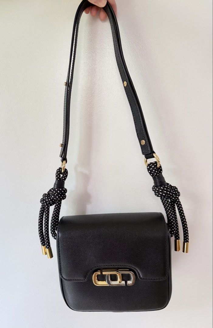 The Marc Jacobs Black Leather Snapshot Camera Bag (Category: Luxury Bags & Wallets) located in Paranaque City. Submitted by balofies (Listing ID 1446978790, Image 2). Description: The Marc Jacobs Snapshot Camera Bag 🖤 Used only twice and stored properly, so it’s in excellent condition. Crafted from black pebbled leather with the signature Marc Jacobs hardware. Features a unique adjustable shoulder strap with cute polka-dot knotted details. The b