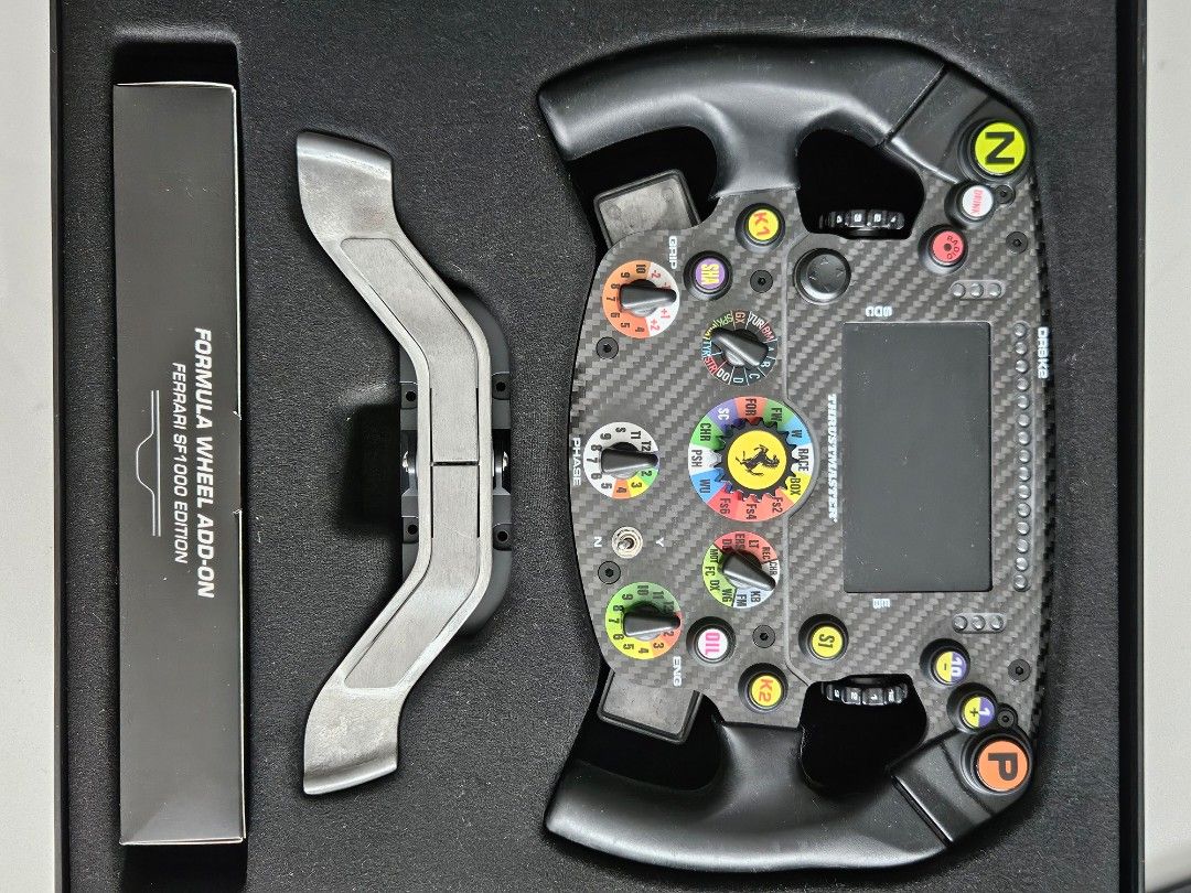 Thrustmaster Ferrari SF1000 Edition Formula Wheel Add-On (Category: Controllers) located in Paranaque City. Submitted by FitNHobbies (Listing ID 1446950865, Image 3). Description: THRUSTMASTER SF1000 FORMULA WHEEL ADD-ON - Authentic replica of the Ferrari SF1000 F1 wheel - 109 sq. inch face with 100% carbon fiber construction (not real carbon fiber) - Integrated 4.3-inch display for real-time telemetry - Premium metal faceplate included - Fully c