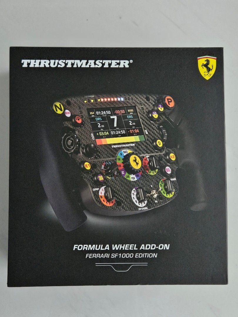 Thrustmaster Ferrari SF1000 Edition Formula Wheel Add-On (Category: Controllers) located in Paranaque City. Submitted by FitNHobbies (Listing ID 1446950865, Image 1). Description: THRUSTMASTER SF1000 FORMULA WHEEL ADD-ON - Authentic replica of the Ferrari SF1000 F1 wheel - 109 sq. inch face with 100% carbon fiber construction (not real carbon fiber) - Integrated 4.3-inch display for real-time telemetry - Premium metal faceplate included - Fully c