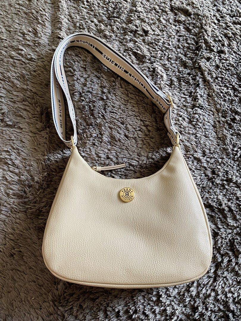 Tommy Hilfiger Beige Shoulder Bag with Logo Strap (Category: Shoulder Bags) located in Quezon City. Submitted by jergaragesale (Listing ID 1446924623, Image 1). Description: Used Tommy Hilfiger beige shoulder bag with logo strap and gold hardware. Pebbled faux leather, perfect for everyday essentials. Clean, simple design. It has minimal flaws, please see photos. What u see is what u get..