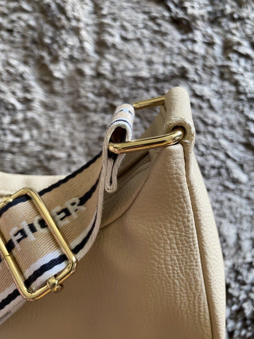 Tommy Hilfiger Beige Shoulder Bag with Logo Strap (Category: Shoulder Bags) located in Quezon City. Submitted by jergaragesale (Listing ID 1446924623, Image 3). Description: Used Tommy Hilfiger beige shoulder bag with logo strap and gold hardware. Pebbled faux leather, perfect for everyday essentials. Clean, simple design. It has minimal flaws, please see photos. What u see is what u get..