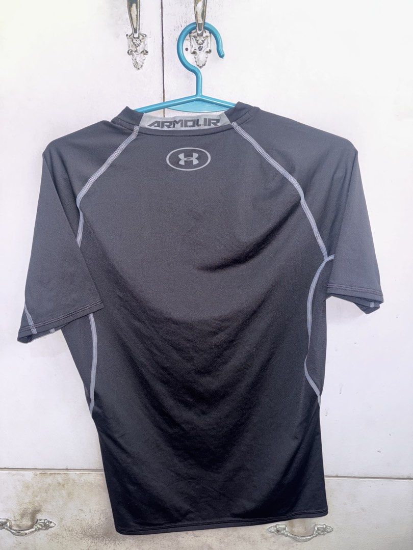 Under Armour Black Short Sleeve Compression T-Shirt (Category: Activewear) located in Pasig City. Submitted by timmybatoon (Listing ID 1446982115, Image 2). Description: Under Armour Heat Gear Compression Shirt (BLACK) Size on tag: XL Dimensions: 19inW x 25.5inL Price: 700 - Black Under Armour short sleeve shirt - Compression fit - Lightweight and breathable material - Ideal for workouts or layering - Under Armour logo on front and back - 'ARMOUR