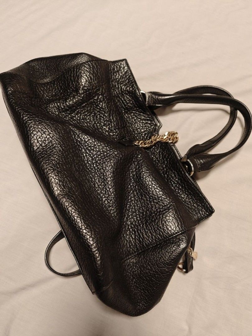 Versace Black Bag (Category: Luxury Bags & Wallets) located in Quezon City. Submitted by liz11888 (Listing ID 1447068252, Image 1). Description: This is a Versace Collection black leather tote bag. Key Features Material: Textured black leather Hardware: Silver-toned metal accents Design: Dual top handles, detachable shoulder strap, and a prominent Medusa pendant hanging from a thick chain link RFS: Saving for a new bag Perfect for an everyday off