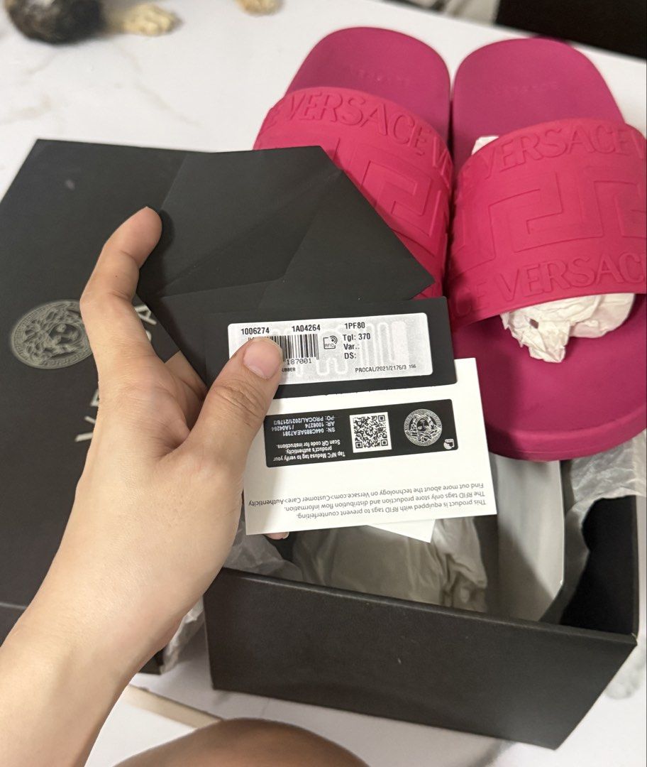 Versace Pink Medusa Biggie Slides (Category: Slippers and slides) located in Manila. Submitted by darlabebe03 (Listing ID 1446975685, Image 3). Description: - Authentic Versace slides in vibrant pink - Features iconic Medusa Biggie motif - Comes with original box and authenticity cards - Soles show some signs of wear from use - Ideal for casual wear.