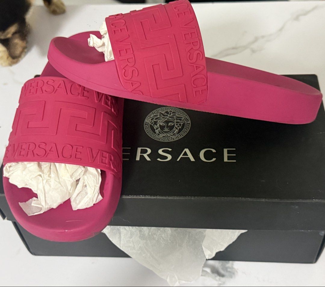 Versace Pink Medusa Biggie Slides (Category: Slippers and slides) located in Manila. Submitted by darlabebe03 (Listing ID 1446975685, Image 2). Description: - Authentic Versace slides in vibrant pink - Features iconic Medusa Biggie motif - Comes with original box and authenticity cards - Soles show some signs of wear from use - Ideal for casual wear.