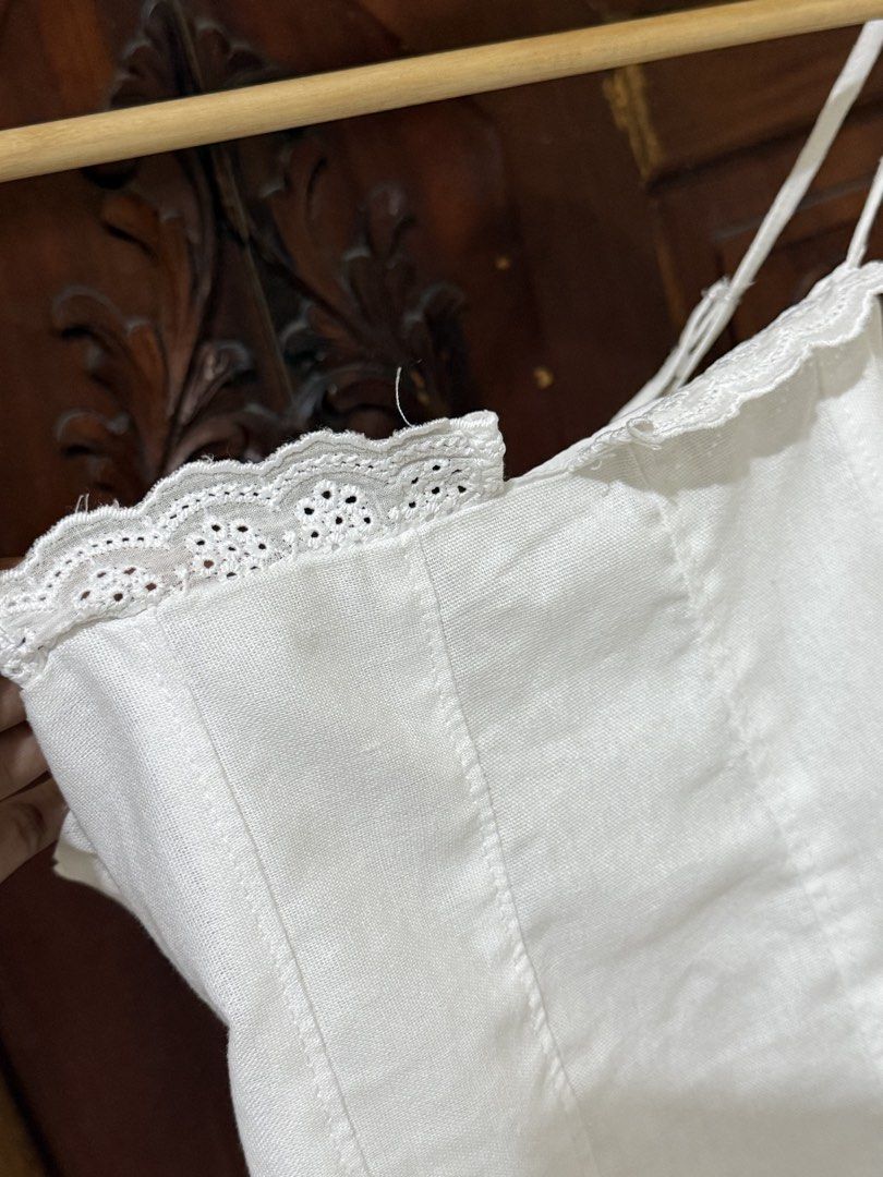 White Lace Trim Corset Top with Adjustable Straps (Category: Sleeveless) located in Iloilo. Submitted by wornwellco (Listing ID 1447002783, Image 2). Description: - White corset top - Delicate lace trim along neckline - Adjustable spaghetti straps - Flattering structured bodice - Versatile for layering or wearing on its own.