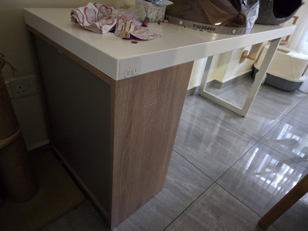 Study Table/Desk (Category: Tables & Sets) located in Singapore. Submitted by meganugget (Listing ID 1447017348, Image 3). Description: - Big white study desk - Modern wood cabinet with door and shelf - Ideal for study or work area - Clean, modern aesthetic - LxW: 150x60cm - Note: Pet beds shown are not included.