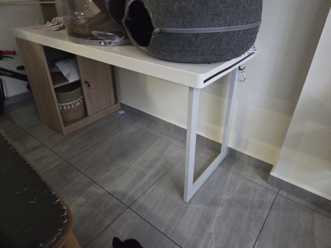 Study Table/Desk (Category: Tables & Sets) located in Singapore. Submitted by meganugget (Listing ID 1447017348, Image 2). Description: - Big white study desk - Modern wood cabinet with door and shelf - Ideal for study or work area - Clean, modern aesthetic - LxW: 150x60cm - Note: Pet beds shown are not included.