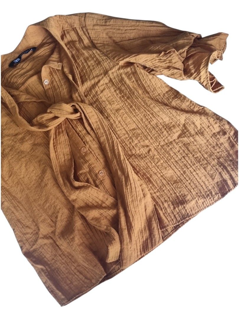 Zara Brown / Tan Textured Tie Neck Blouse (Category: Blouses) located in Quezon City. Submitted by kcobs (Listing ID 1446996429, Image 3). Description: - Brown/Tan Zara blouse - Textured fabric - Tie neck detail - Flutter sleeves - Button-up front - Made in Turkey - Versatile: pairs well with jeans or skirts - worn once only, good condition 👍.