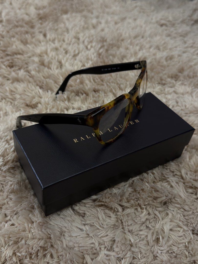 Authentic Ralph Lauren Tortoiseshell Eyeglasses with Case and Box (Category: Sunglasses & Eyewear) located in Manila. Submitted by urbanglasses.mnl (Listing ID 1448741928, Image 3). Description: - Authentic Ralph Lauren eyeglasses - Stylish tortoiseshell pattern on frames - Comes with original hard case - Includes original cleaning cloth - Presented in its original box - Ideal for everyday wear or as a fashion accessory.